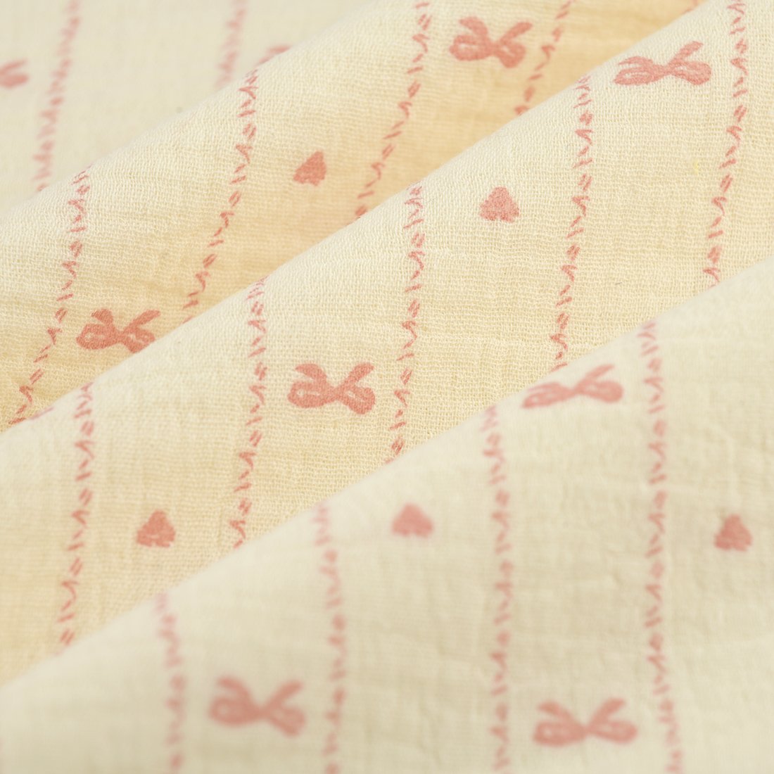 Tissu double gaze noeud coeur ligne rose écru