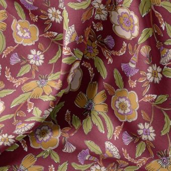 Tissu coton enduit fleur indienne ocre fond bordeaux
