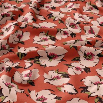 Tissu popeline de viscose fleurs rose pâle fond orangé
